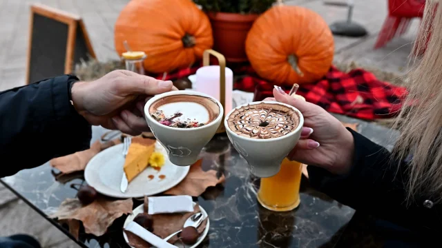 Men And Women Holding Cups Of Coffee